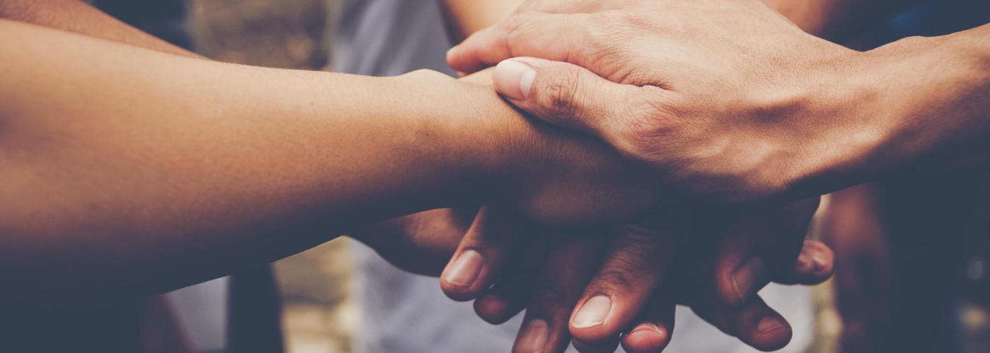 Hands stacked on each other to represent teamwork. 