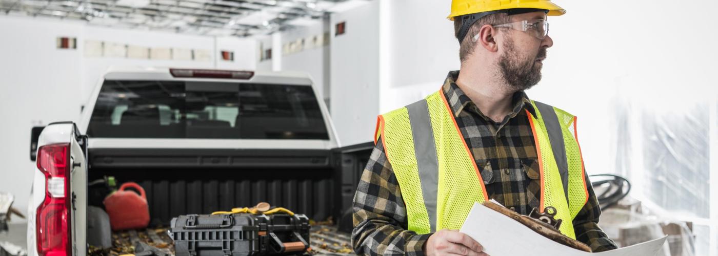 Contractor in front of truck. 