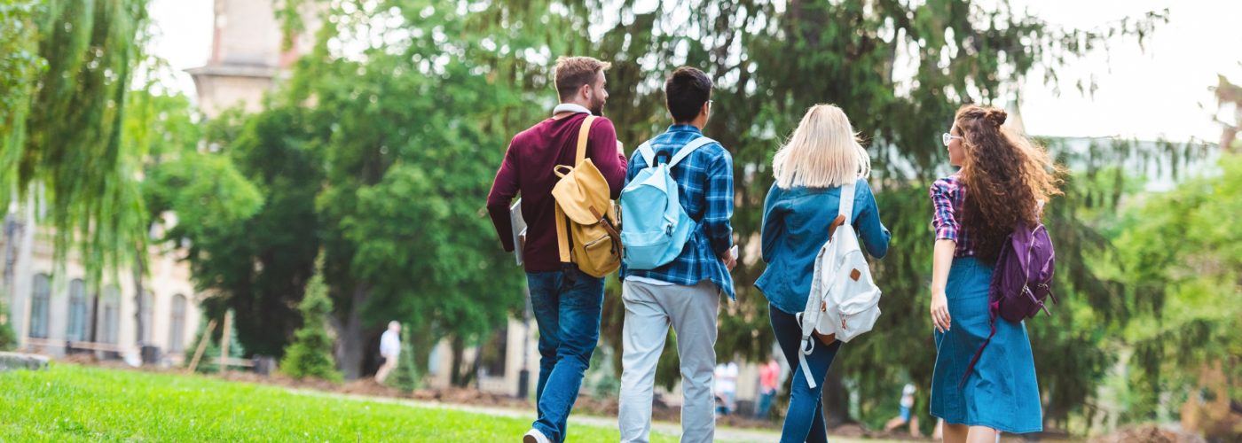 College kids walking with backpacks. 