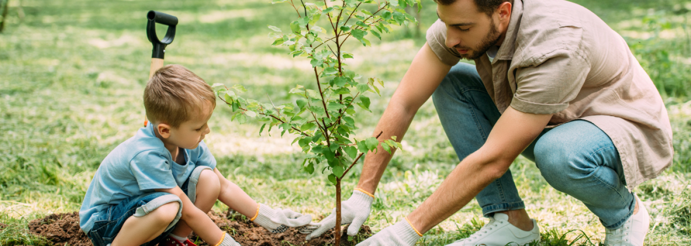 man and child planting a tree