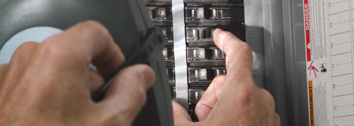 Man checking an electrical panel. 