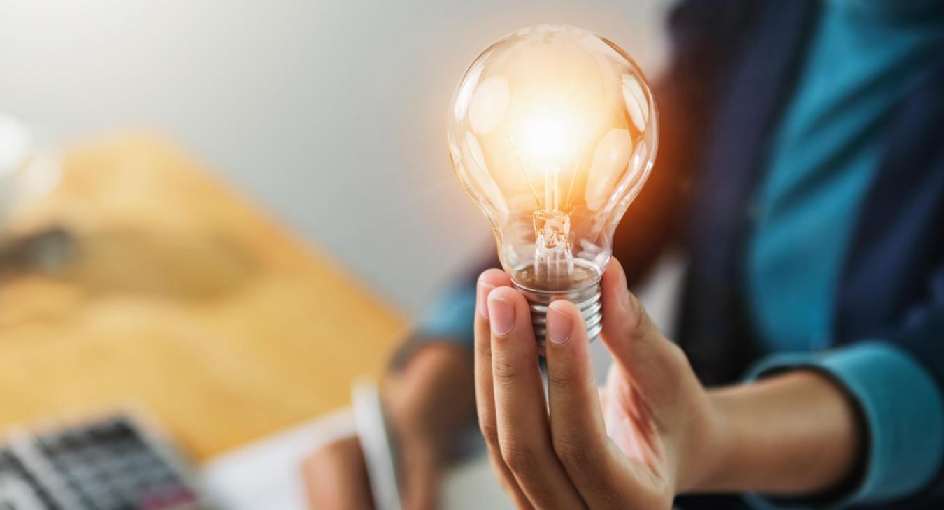 Woman holding a light bulb.