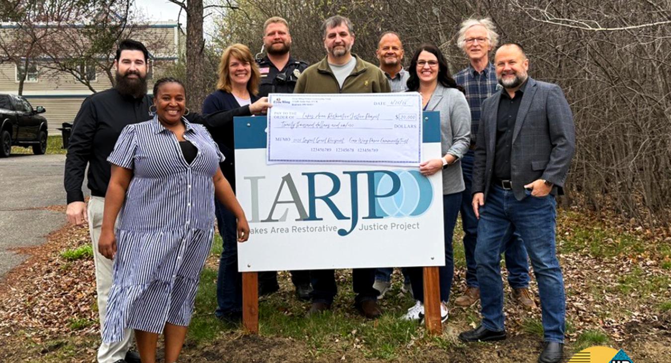 photo of check presentation to lakes area restorative justice project